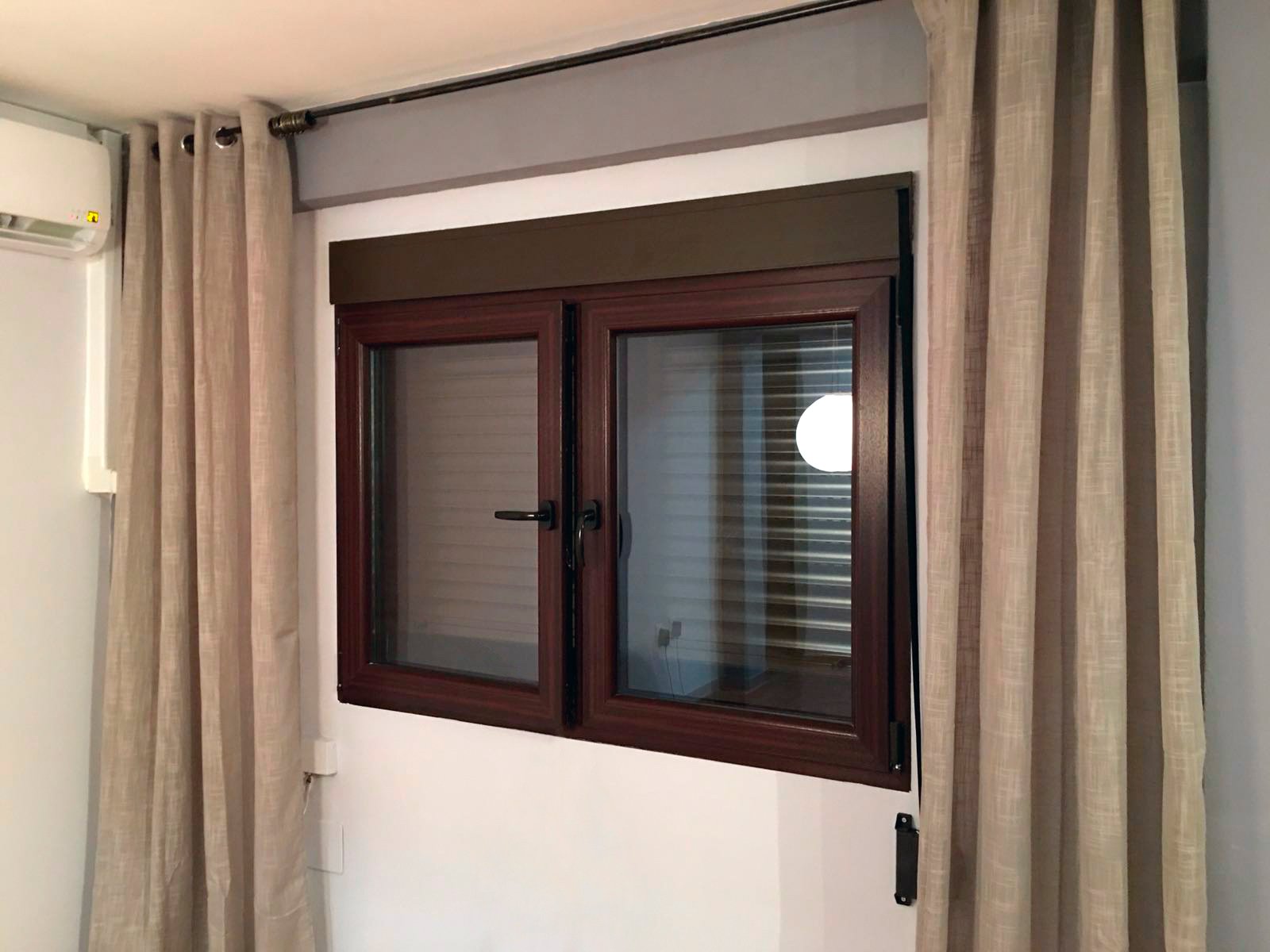 PVC window REHAU tilt-and-turn installed in Valencia mahogany color